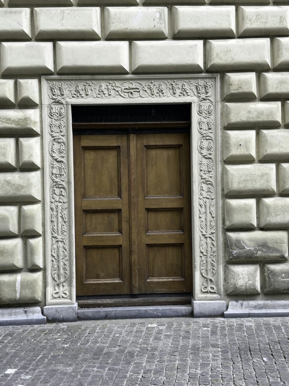 a large wooden door on the side of a building