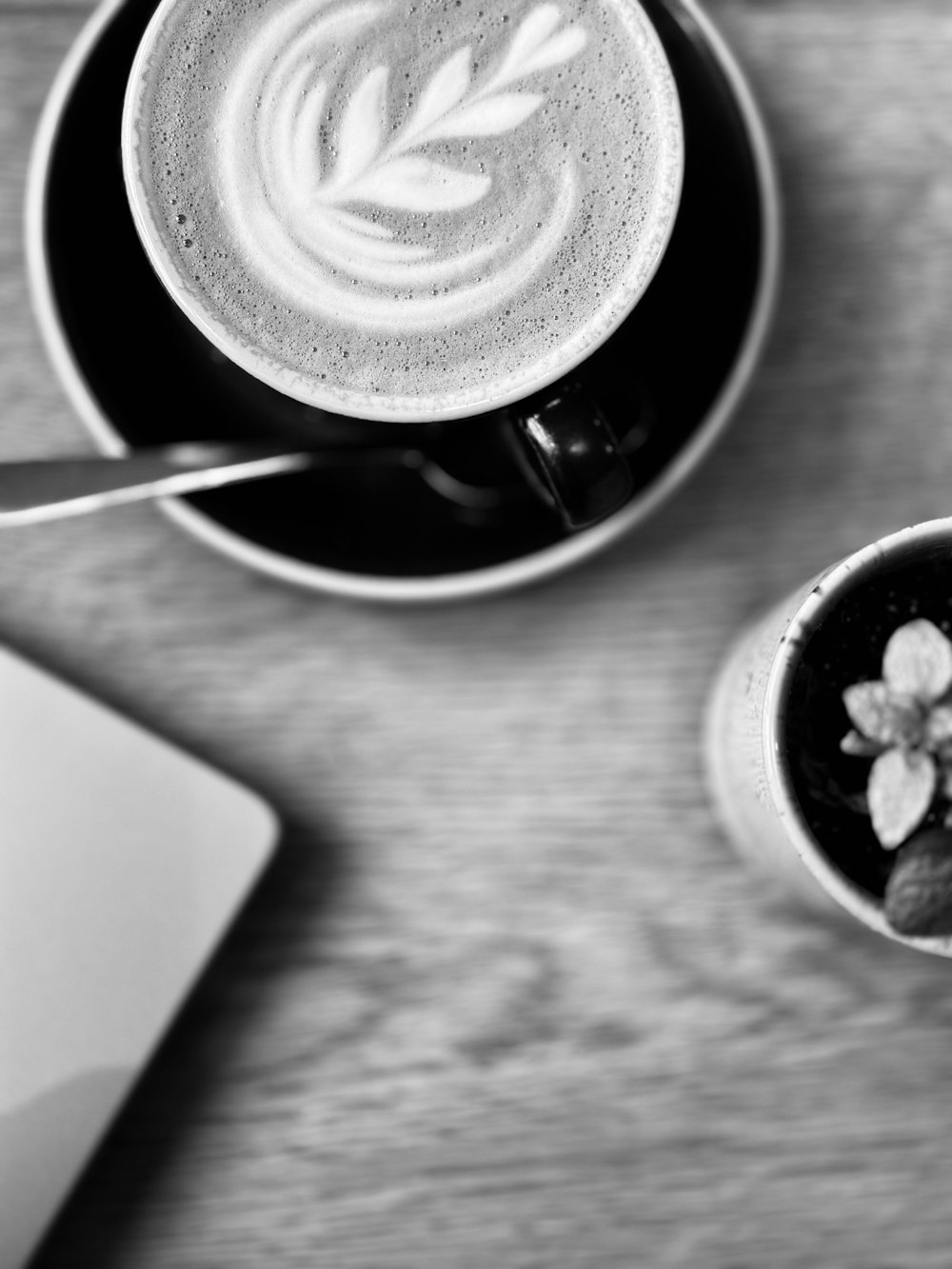 a cup of coffee and a laptop on a table