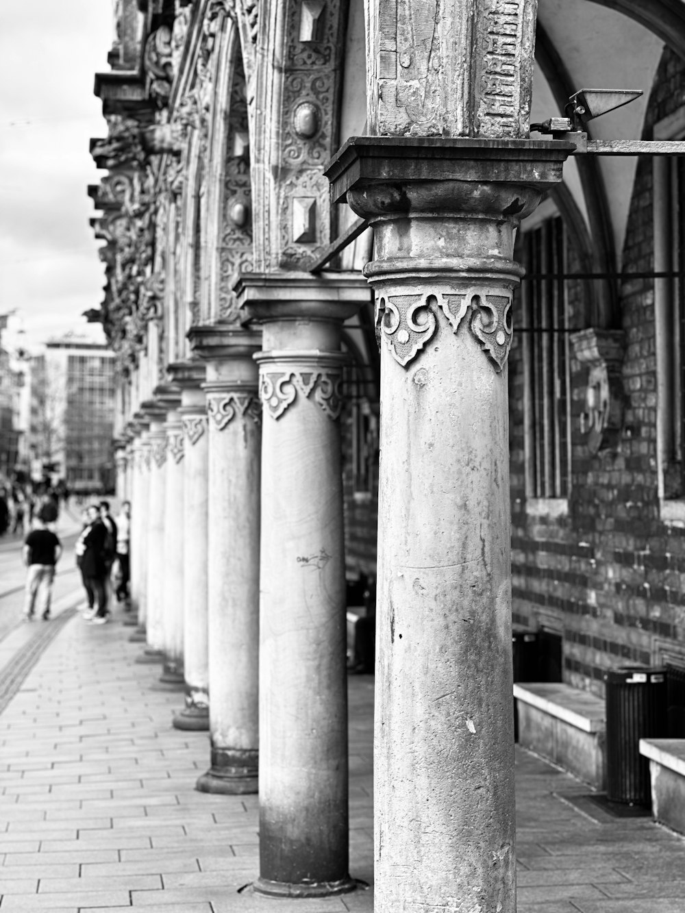 a black and white photo of a row of pillars