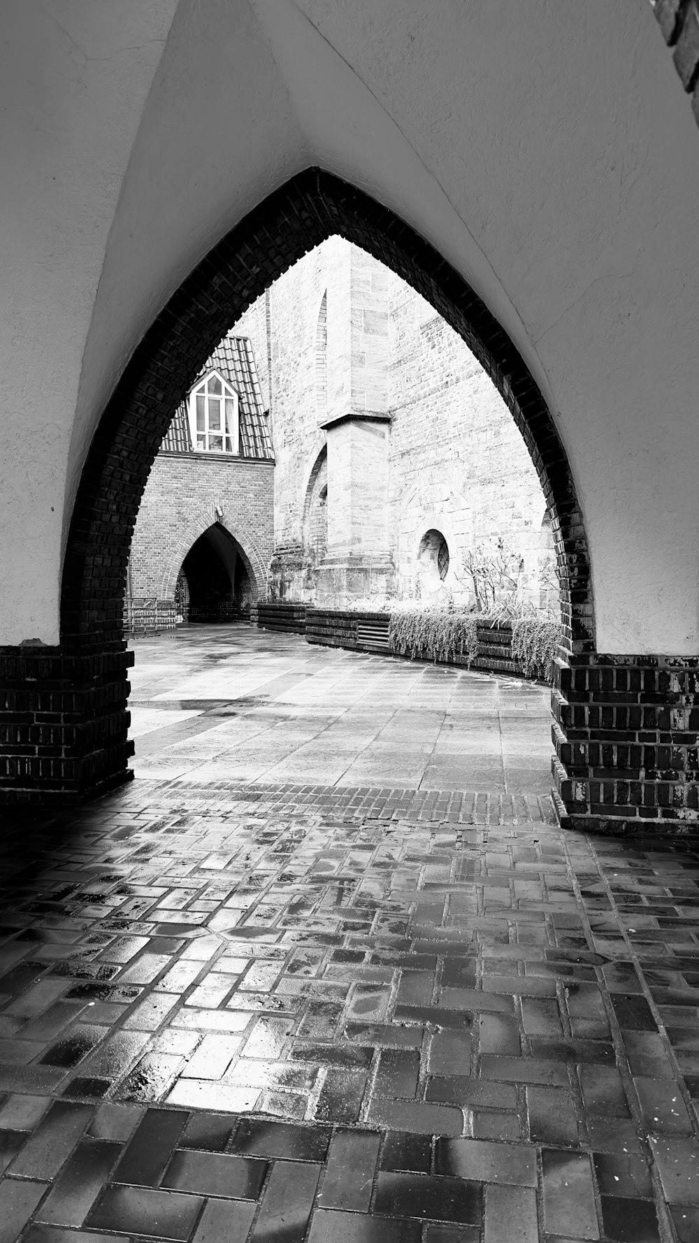 a black and white photo of a brick walkway