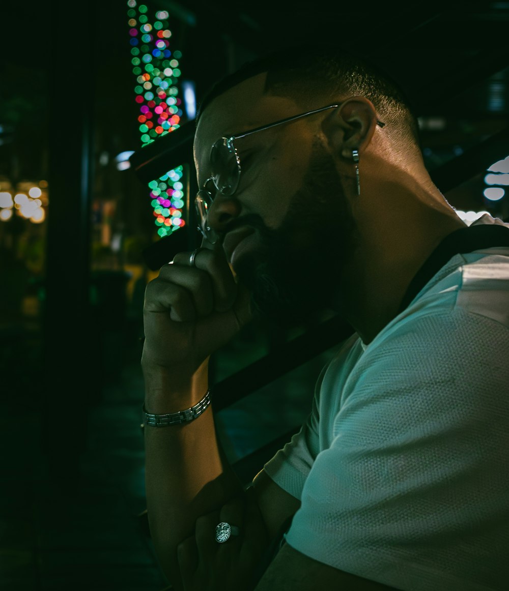 a man with a beard and glasses sitting down