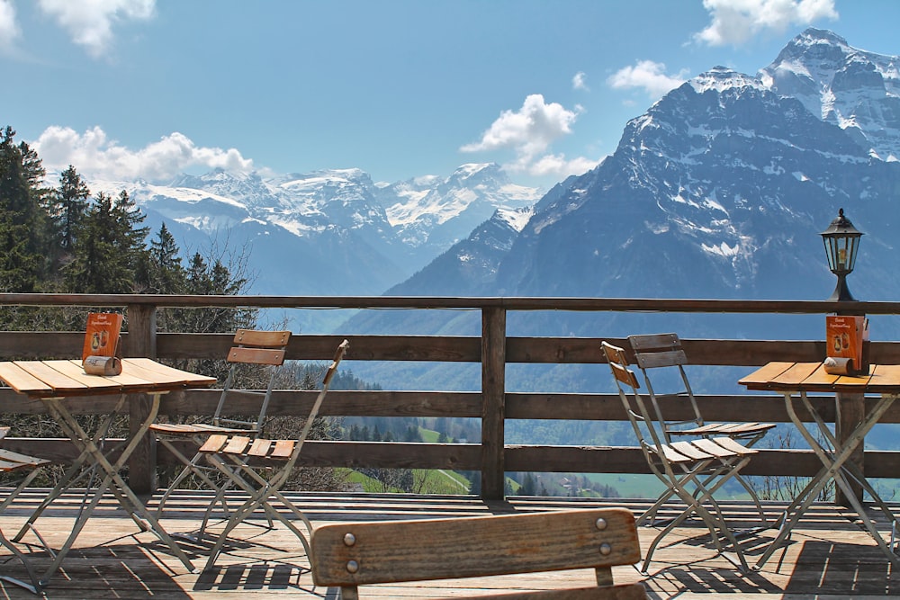 a wooden deck with two chairs and a table on it