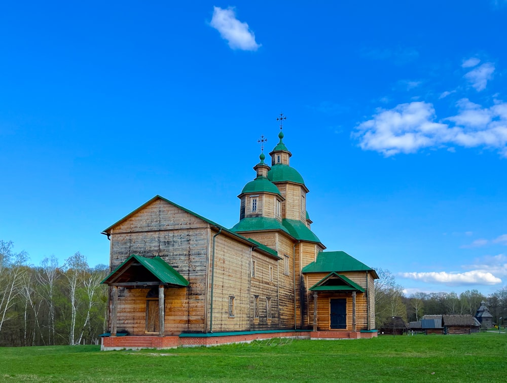 an old wooden church with a green roof