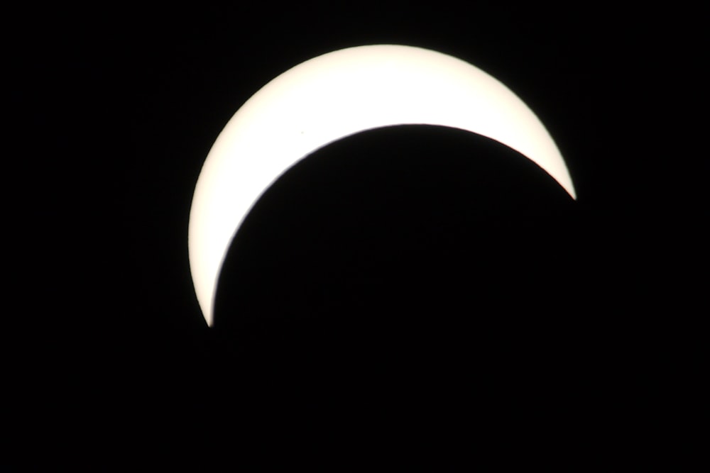 a partial solar eclipse in the dark sky