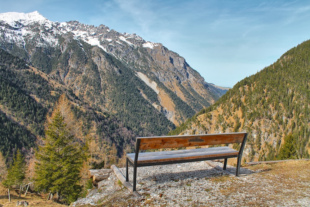 a bench on a mountain overlooking a valley