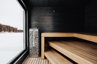 a wooden bench sitting next to a window