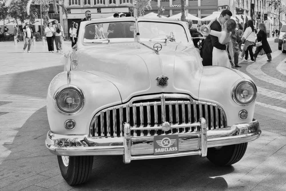 a black and white photo of a vintage car