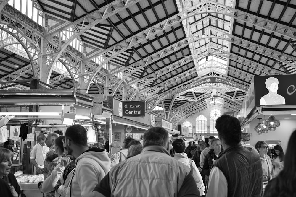 a black and white photo of people in a market
