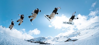 a man flying through the air while riding a snowboard