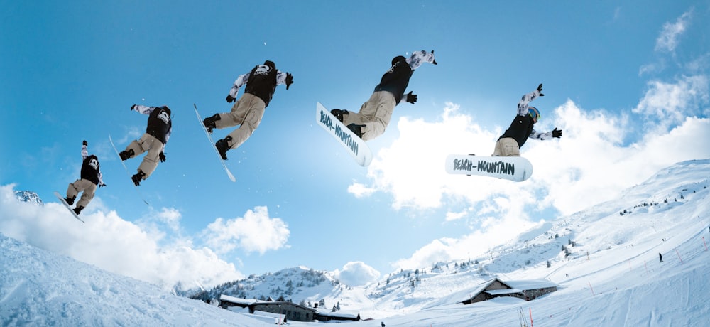 a man flying through the air while riding a snowboard