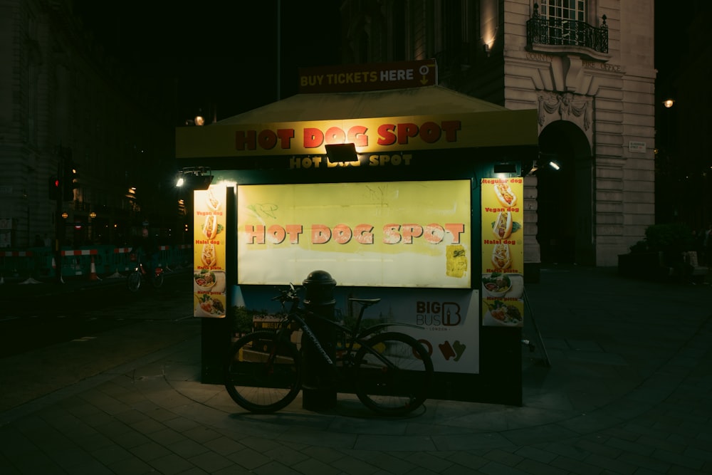 a bike parked in front of a hot dog stand