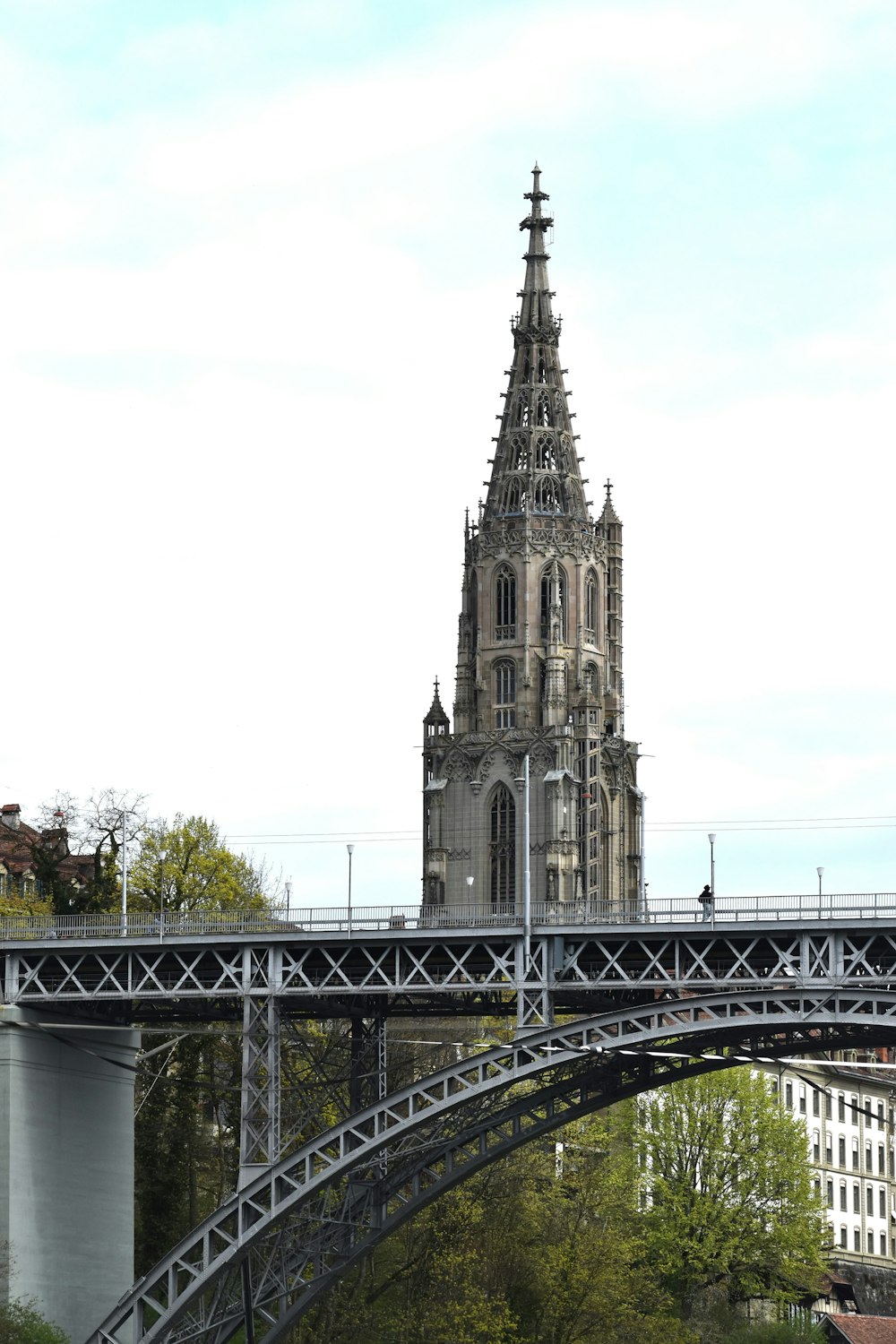 a bridge with a clock tower in the background