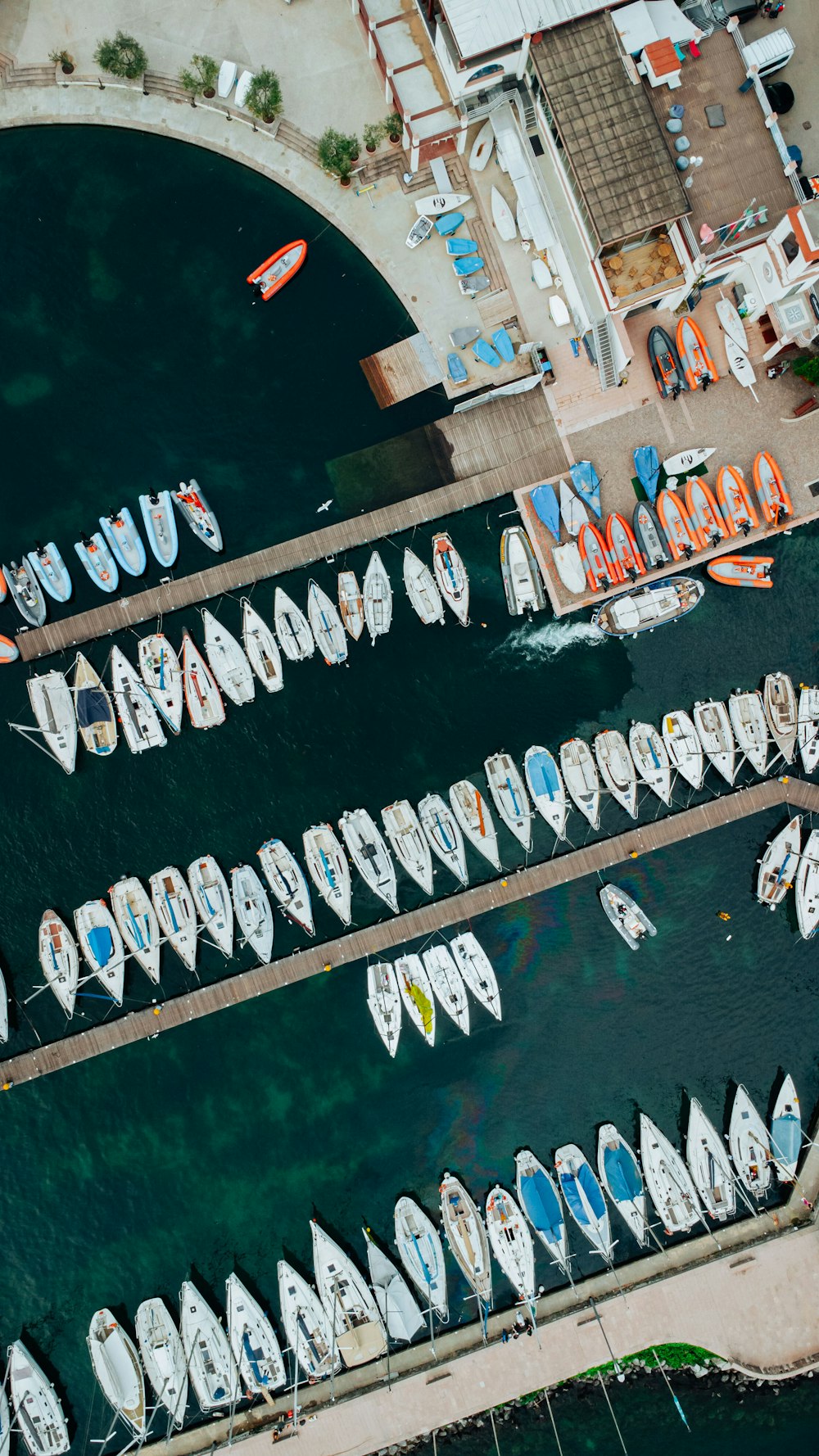 a group of boats parked in a harbor next to each other