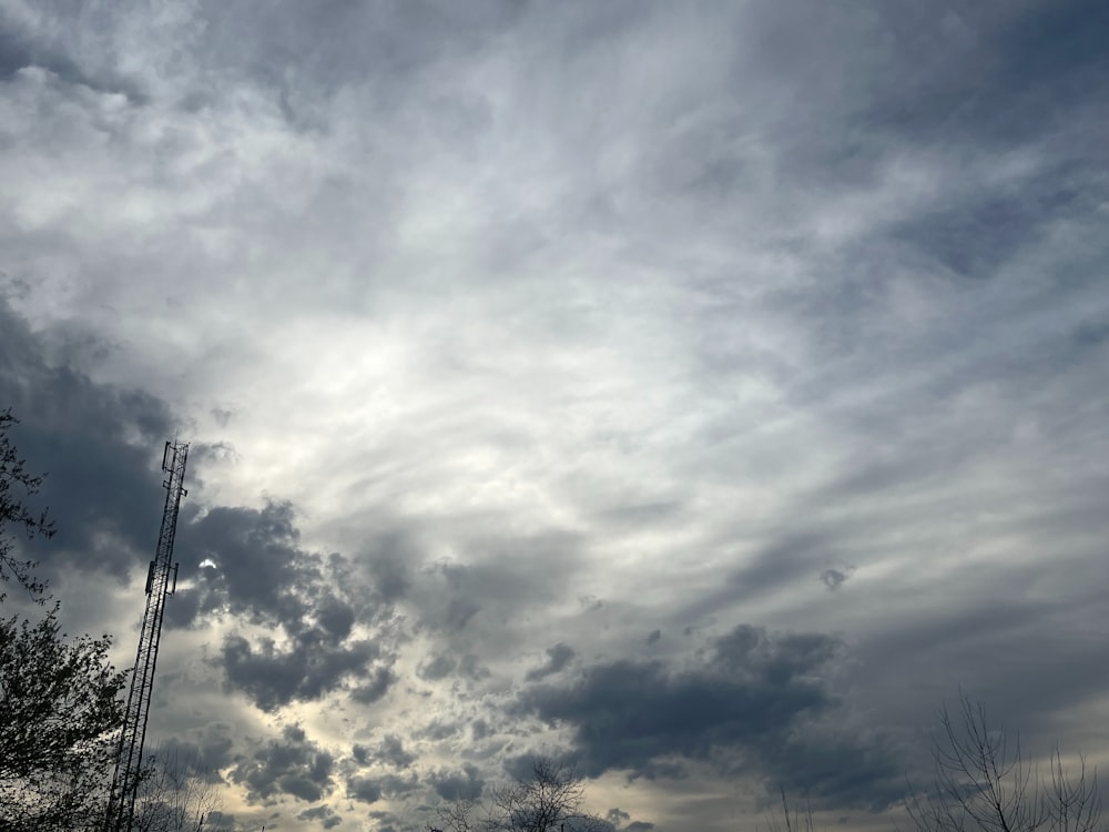 a cloudy sky with a tower in the distance