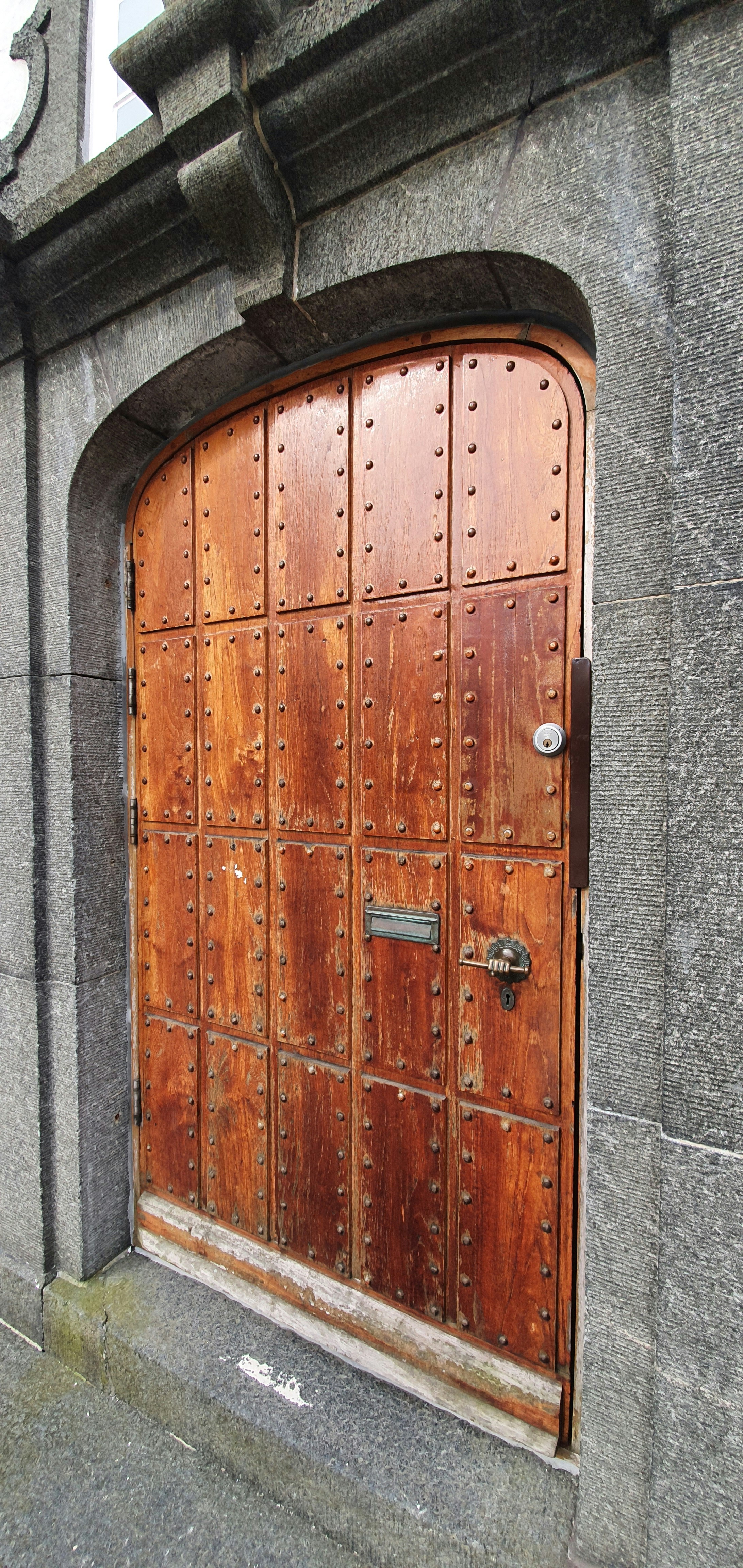 a large wooden door on the side of a building
