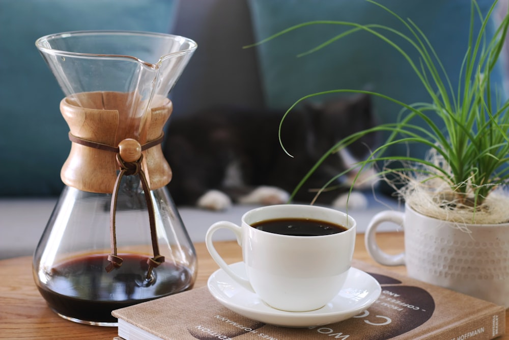 a cup of coffee and a book on a table