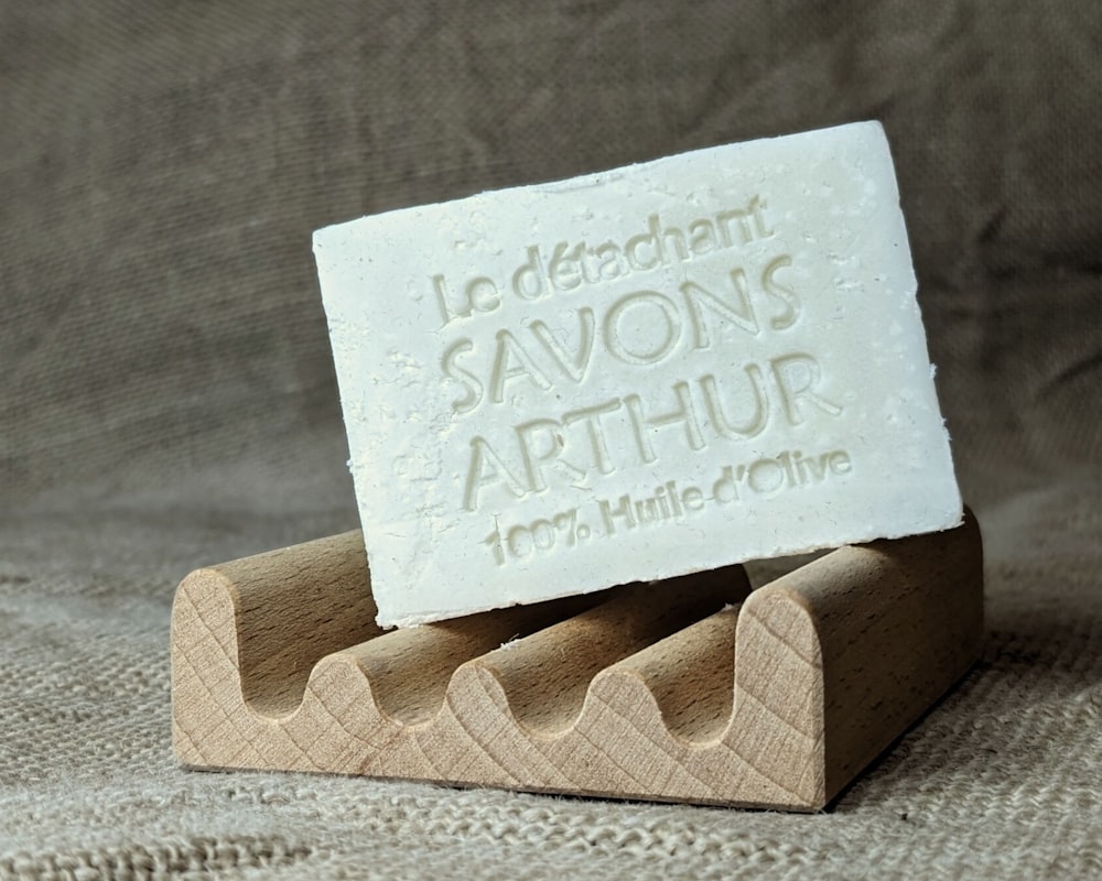 a soap bar sitting on top of a wooden holder