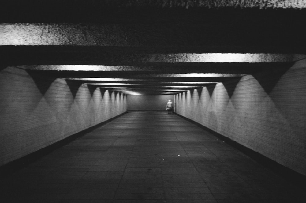 a black and white photo of a long hallway