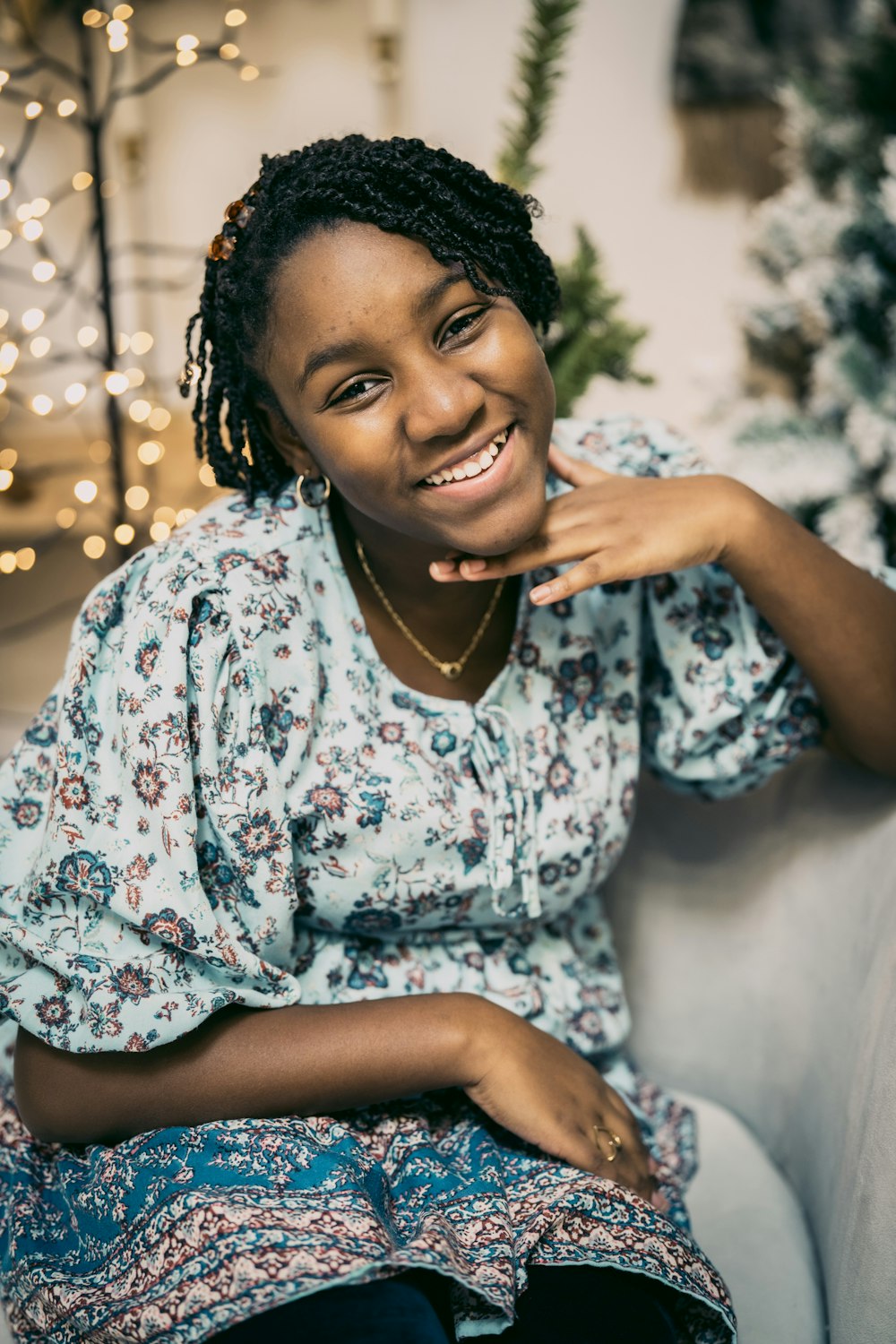 a woman sitting on a couch smiling at the camera