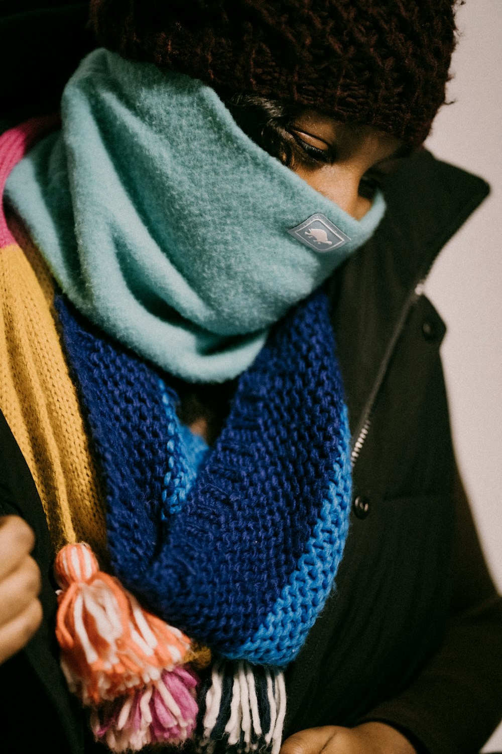 a woman wearing a scarf and a scarf around her neck