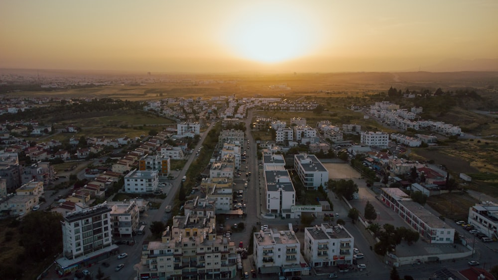 an aerial view of a city at sunset