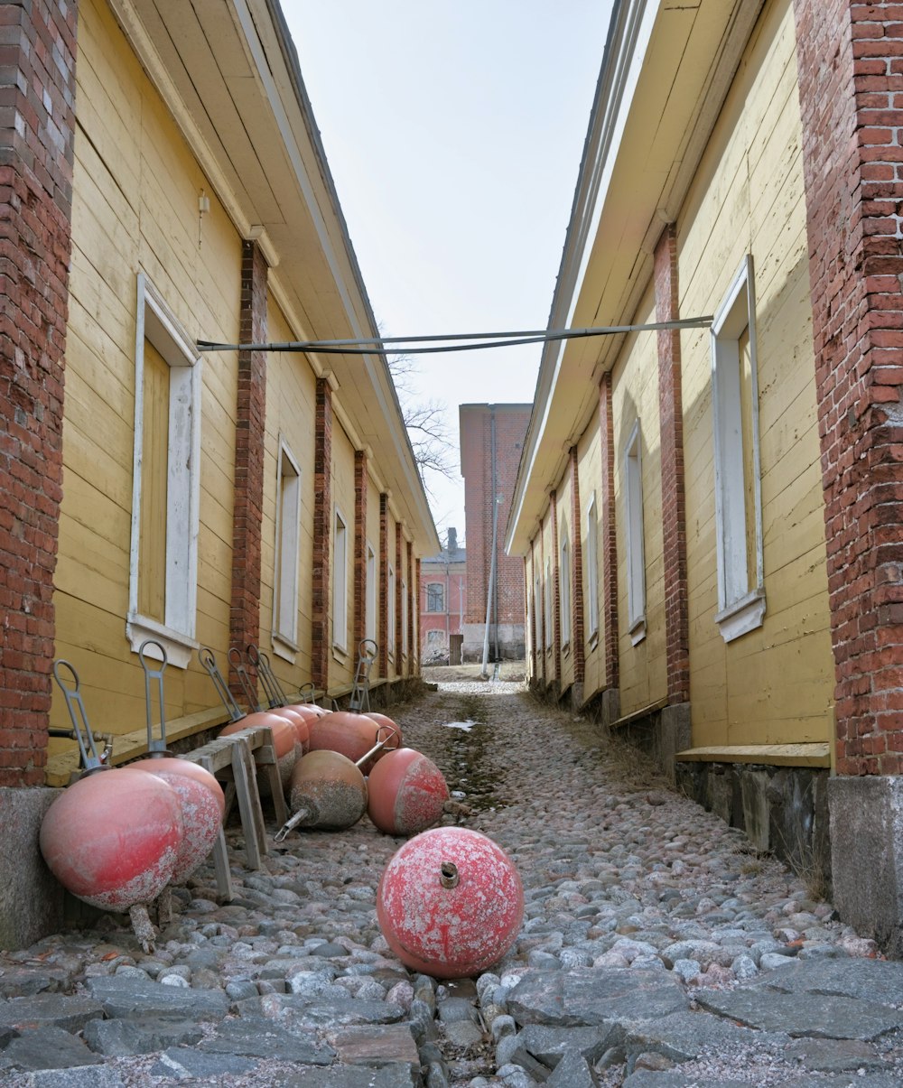 a row of buildings with red and white balls on the ground
