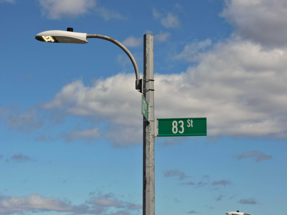 a street light with a street sign on it