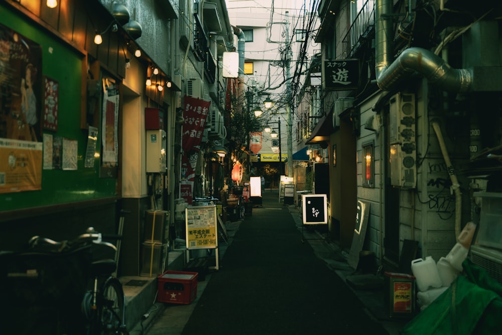 a narrow alley way with signs and lights