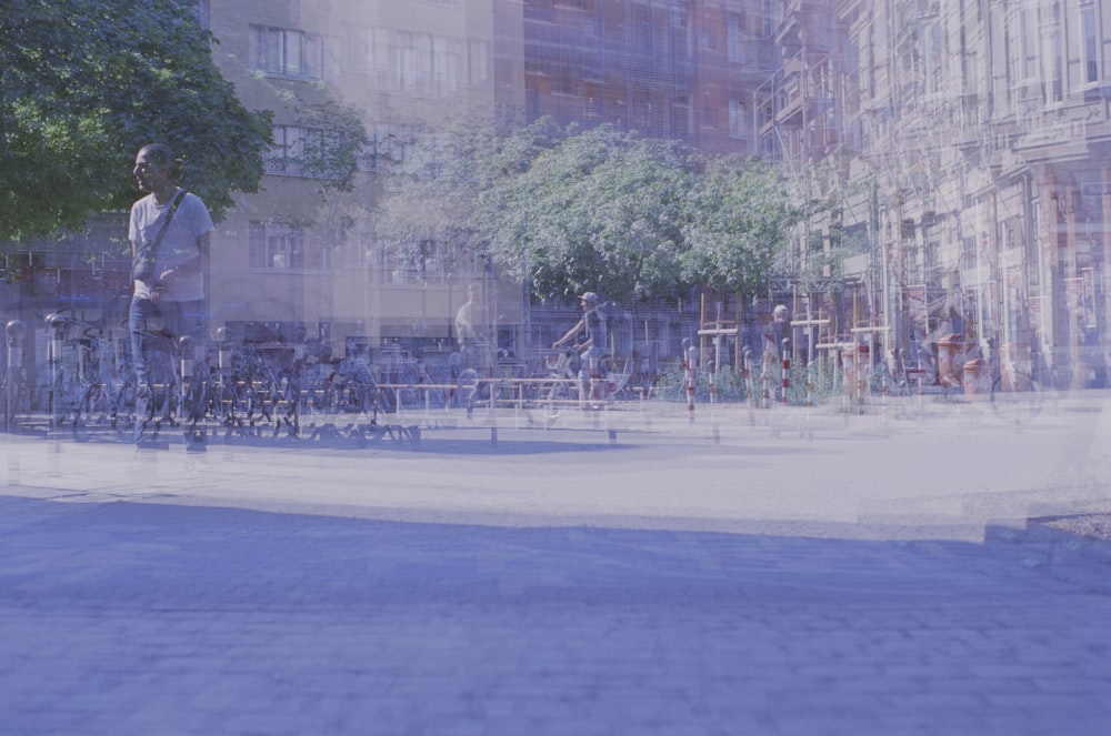 a man riding a skateboard down a street next to tall buildings