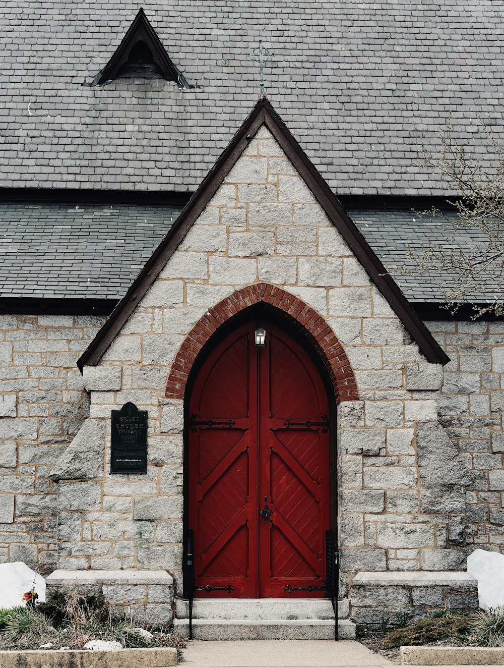 a church with a red door and a clock