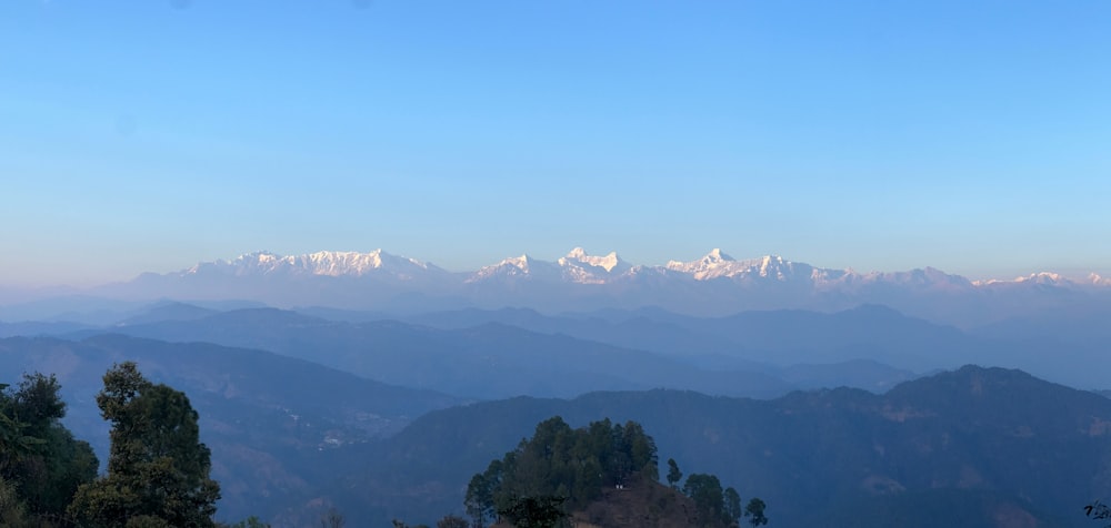 a view of a mountain range with snow capped mountains in the distance