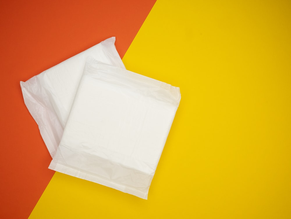 a piece of white paper sitting on top of a yellow and red background