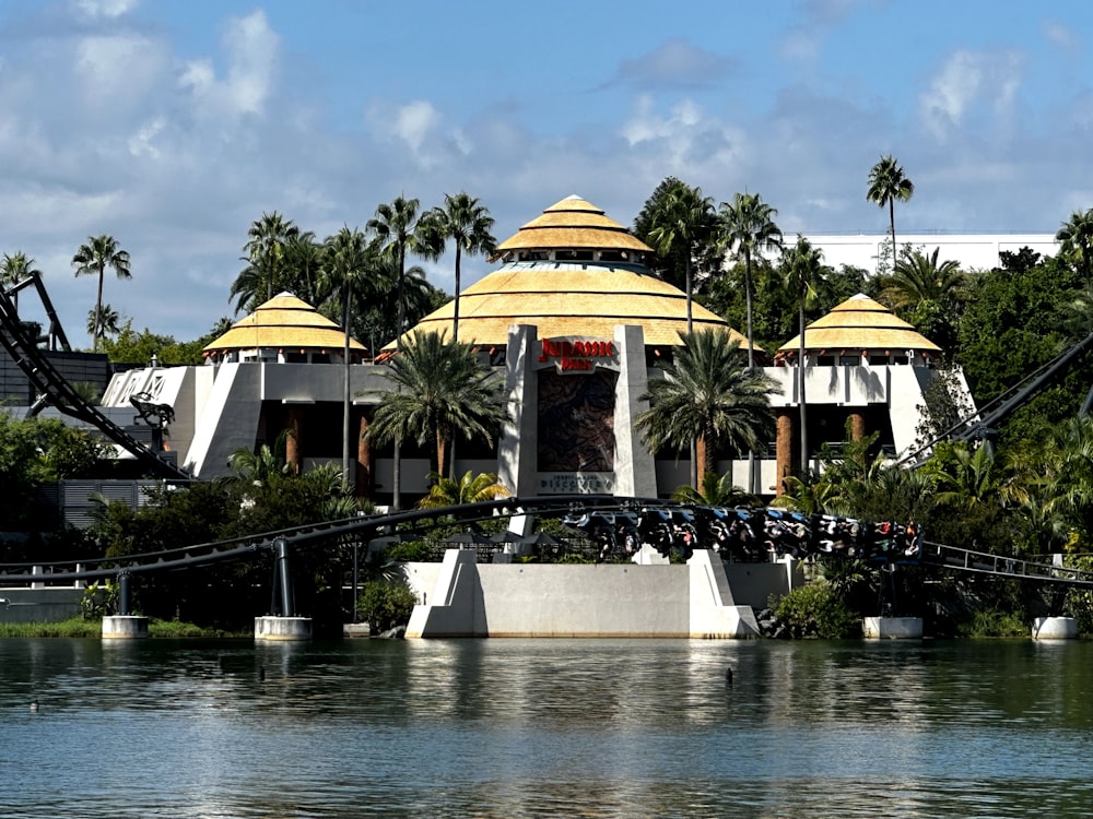 a large building with a yellow roof next to a body of water