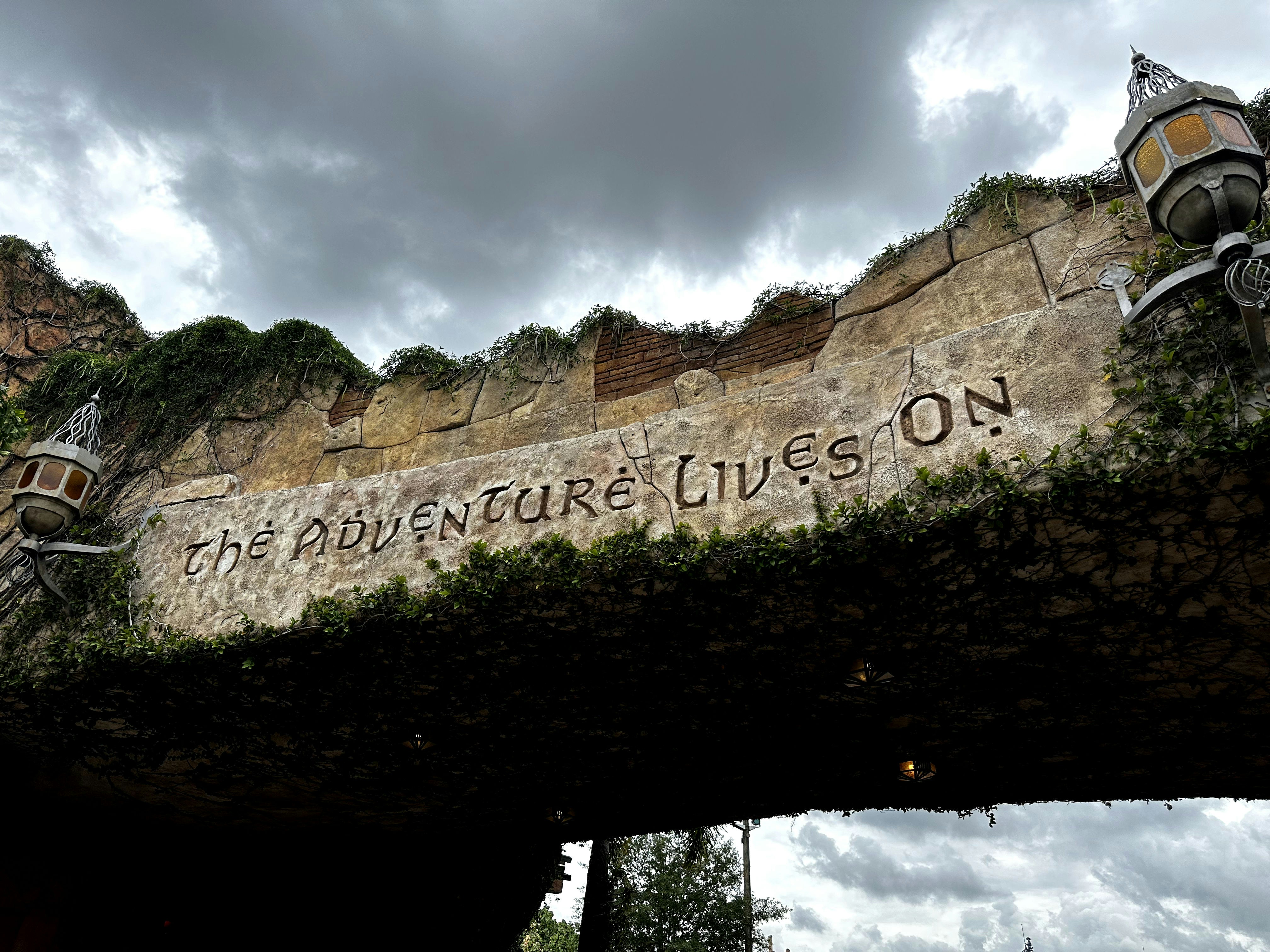 a sign on a bridge that says the adventure lives on