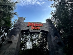a sign for a park with a sky background
