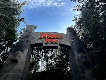 a sign for a park with a sky background