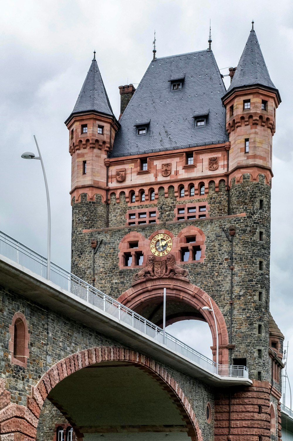 a tall brick building with a clock on it's side