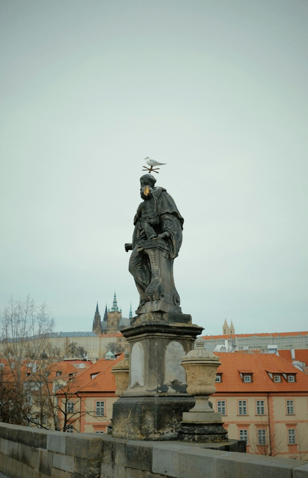a statue of a man with a bird on his head