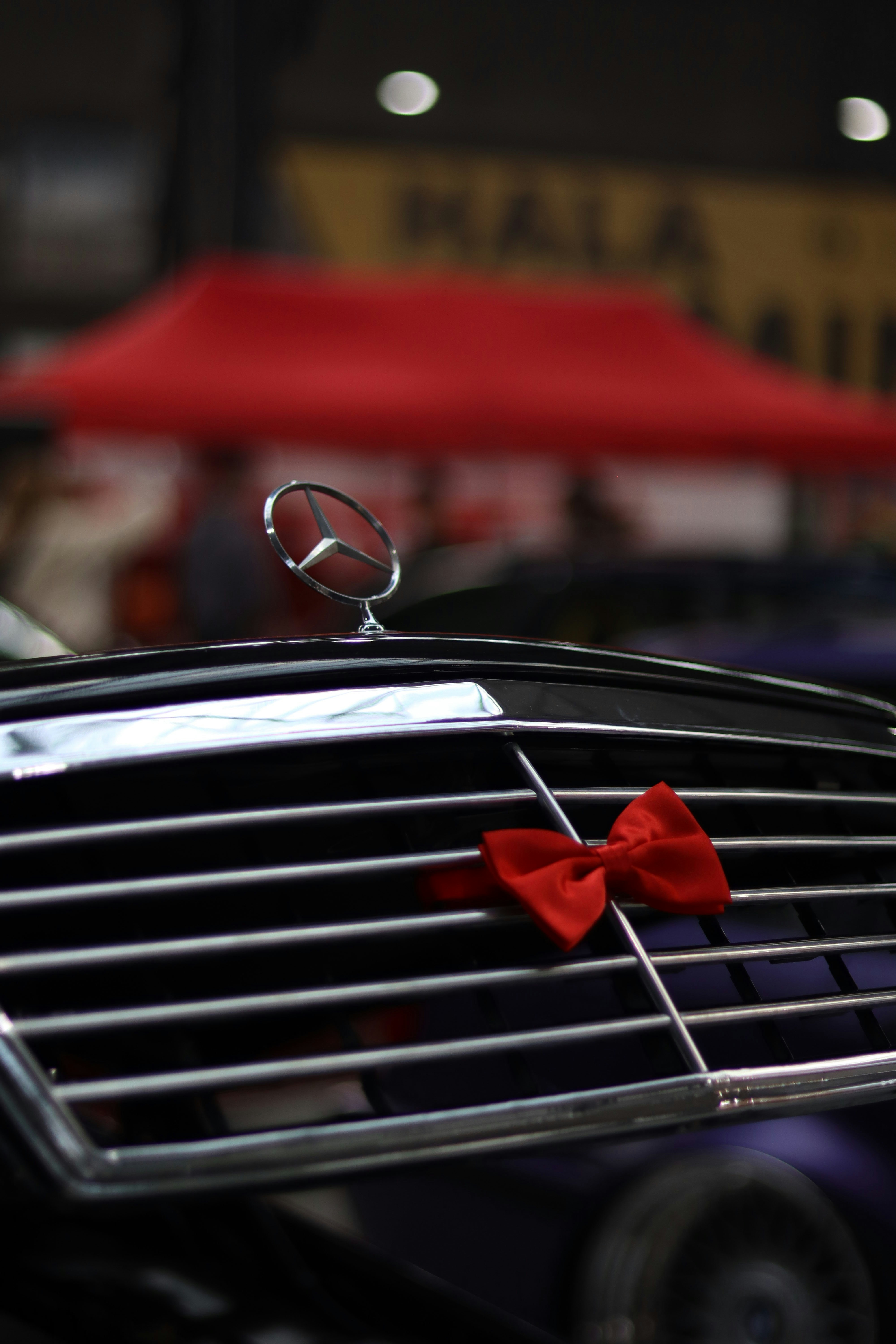 a close up of a grill with a red bow on it