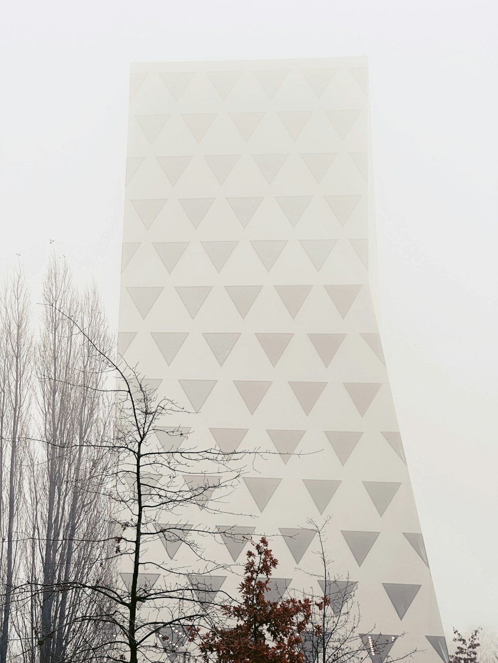 a tall building with a triangular design on the side of it