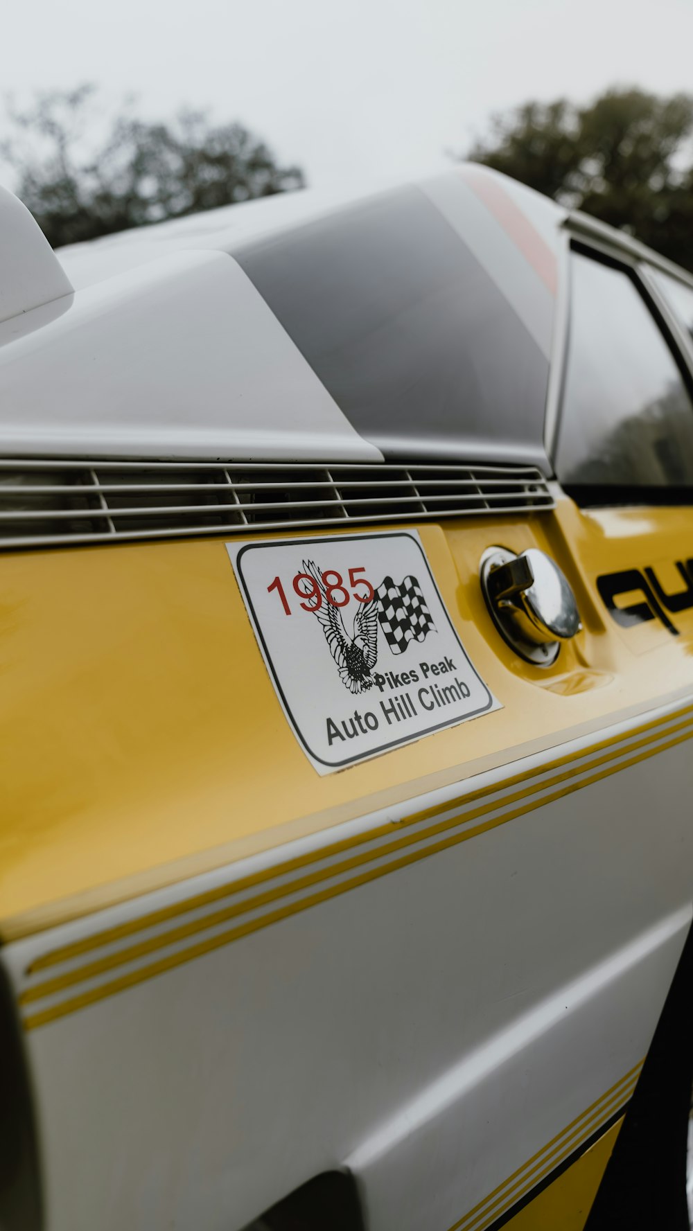 a close up of a yellow and white race car