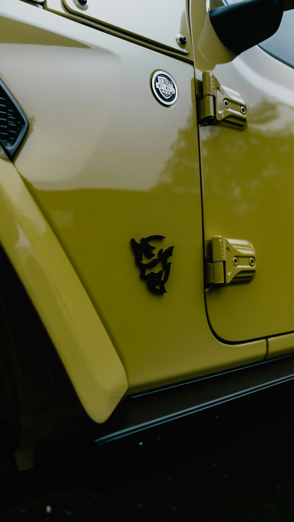 a close up of a yellow jeep door handle