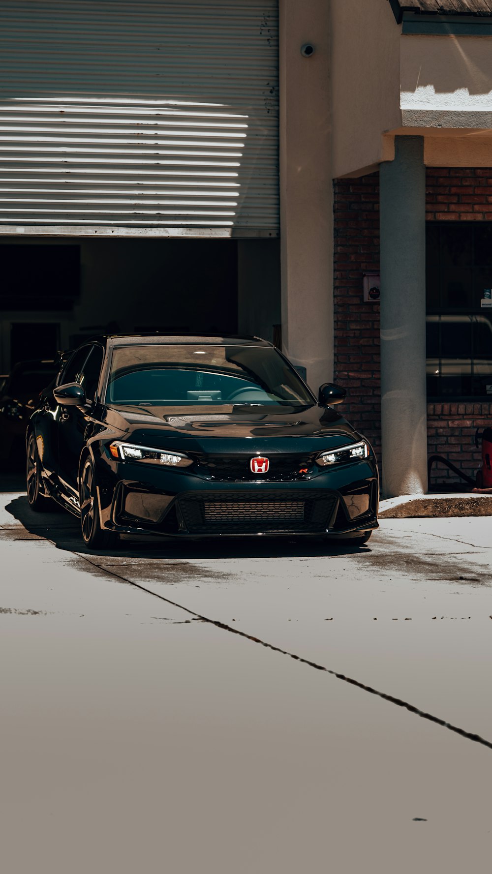 a black car parked in front of a building