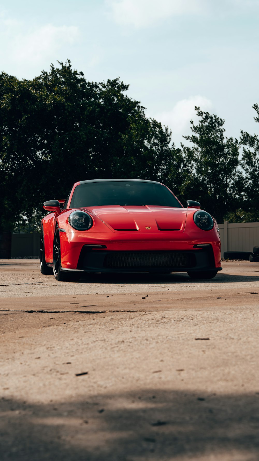 a red sports car parked in a parking lot