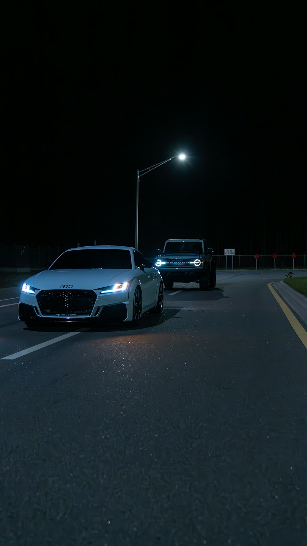 a couple of cars that are sitting in the street