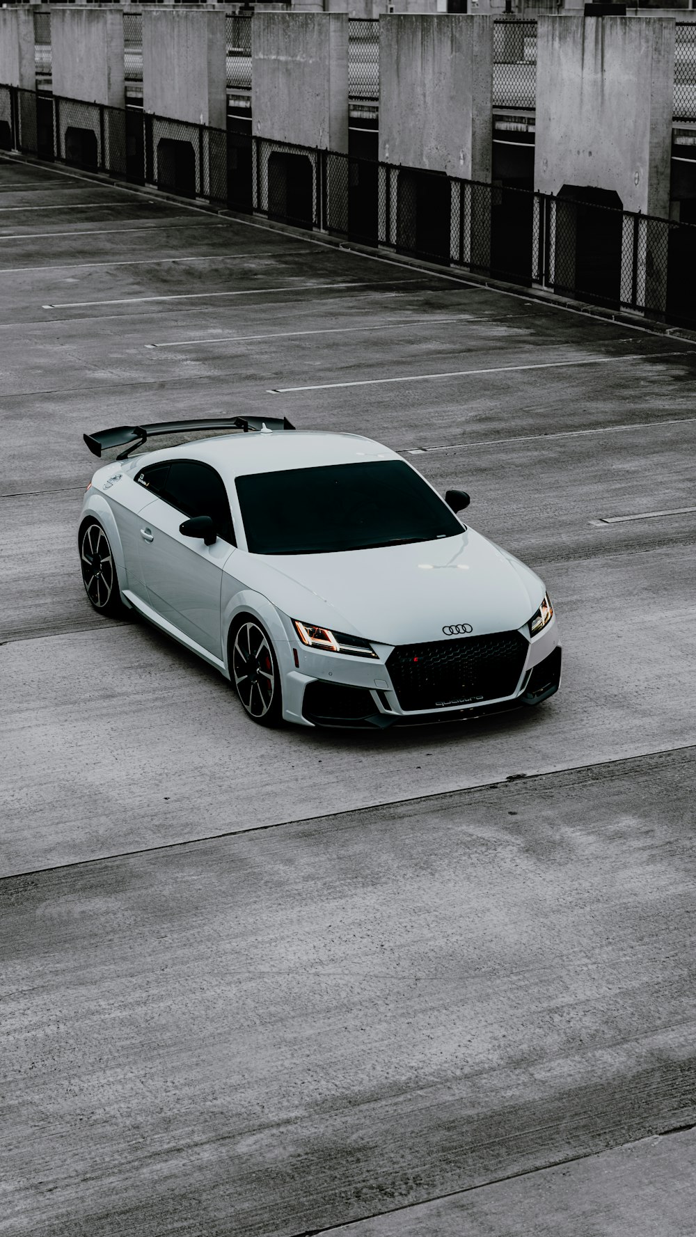 a white sports car parked in a parking lot