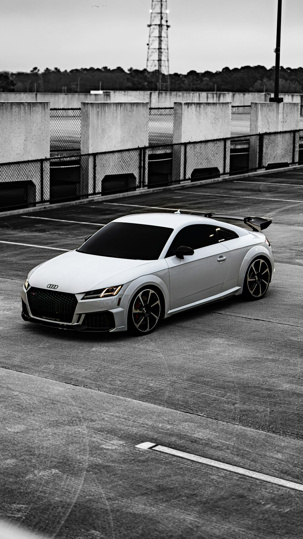 a white sports car parked in a parking lot