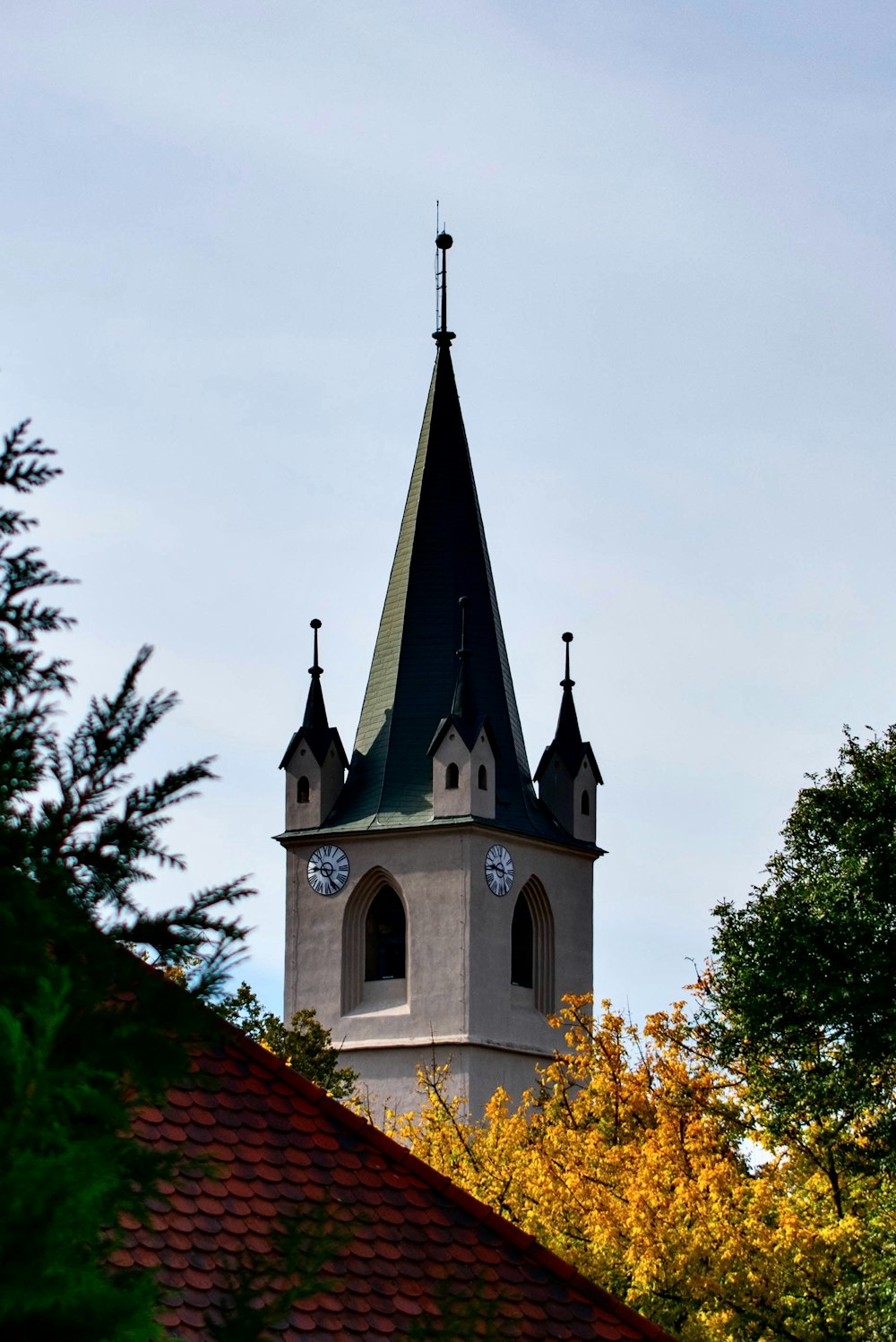 a church steeple with a clock on each of it's sides