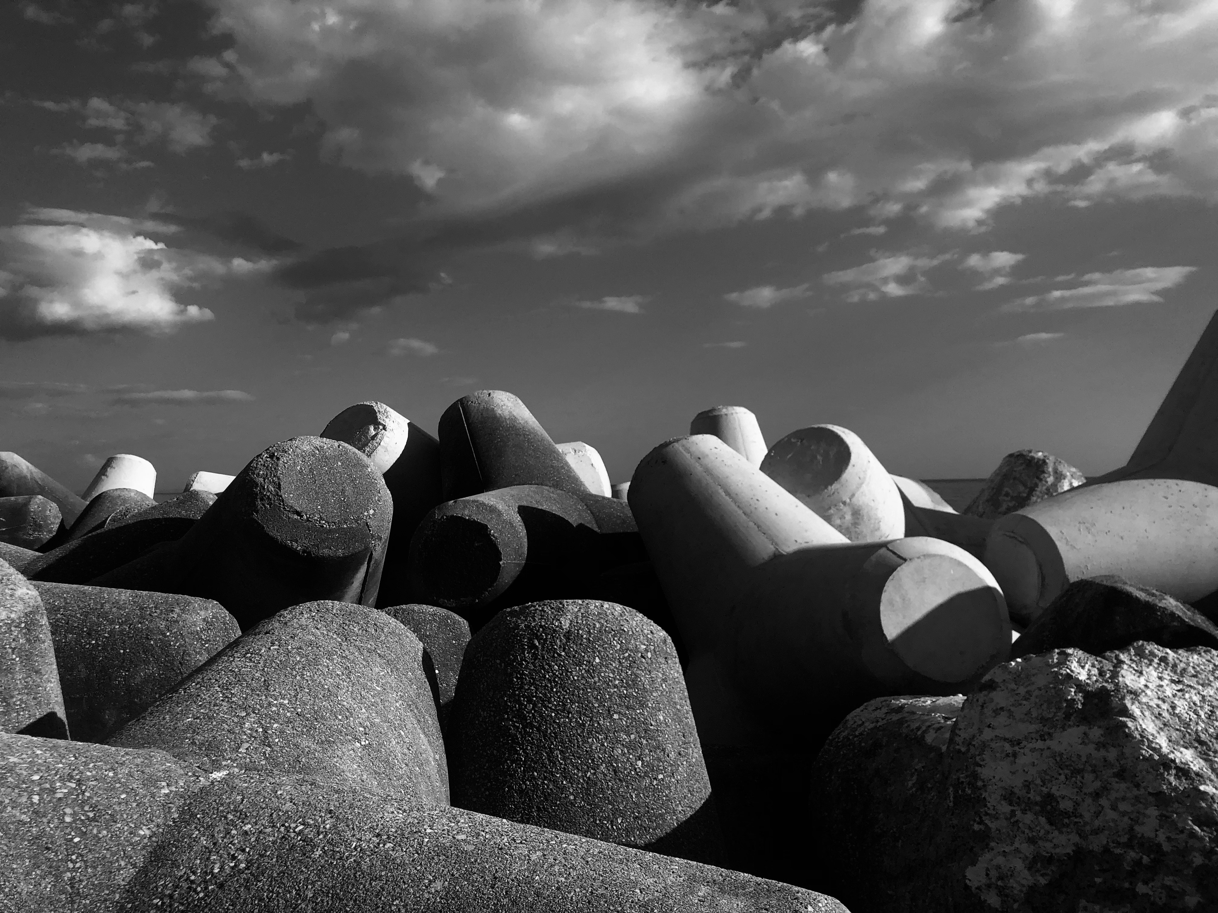 A black and white photo of rocks on the beach photo – Free Italy Image ...