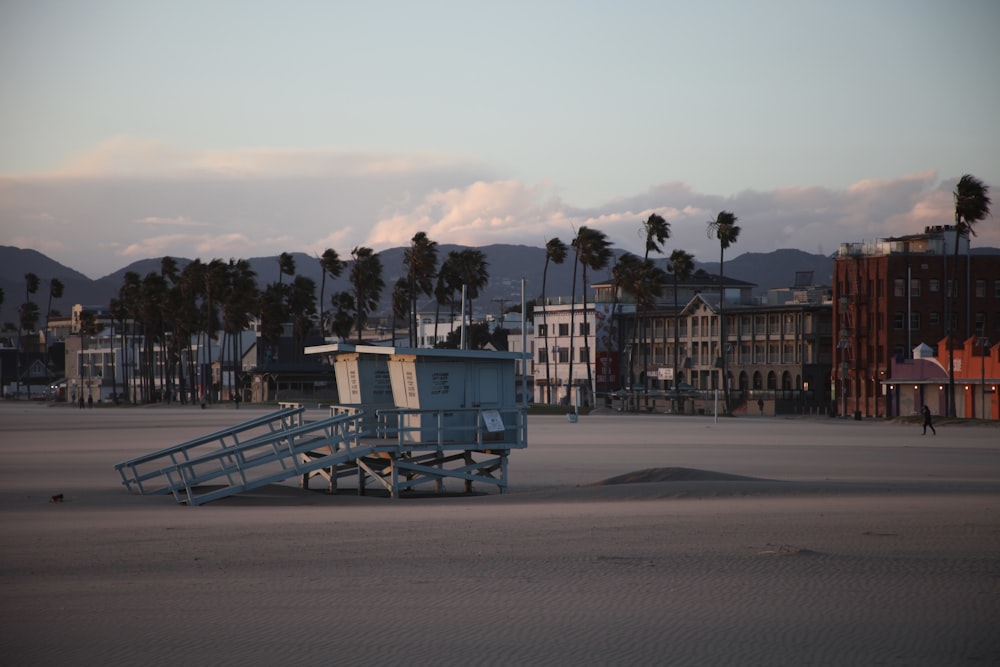 a lifeguard tower sitting on top of a sandy beach